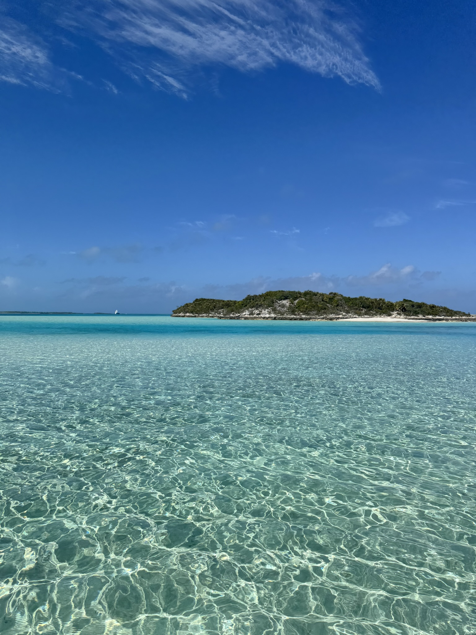 A small cay ringed by crystal-clear turquoise water in the Exumas