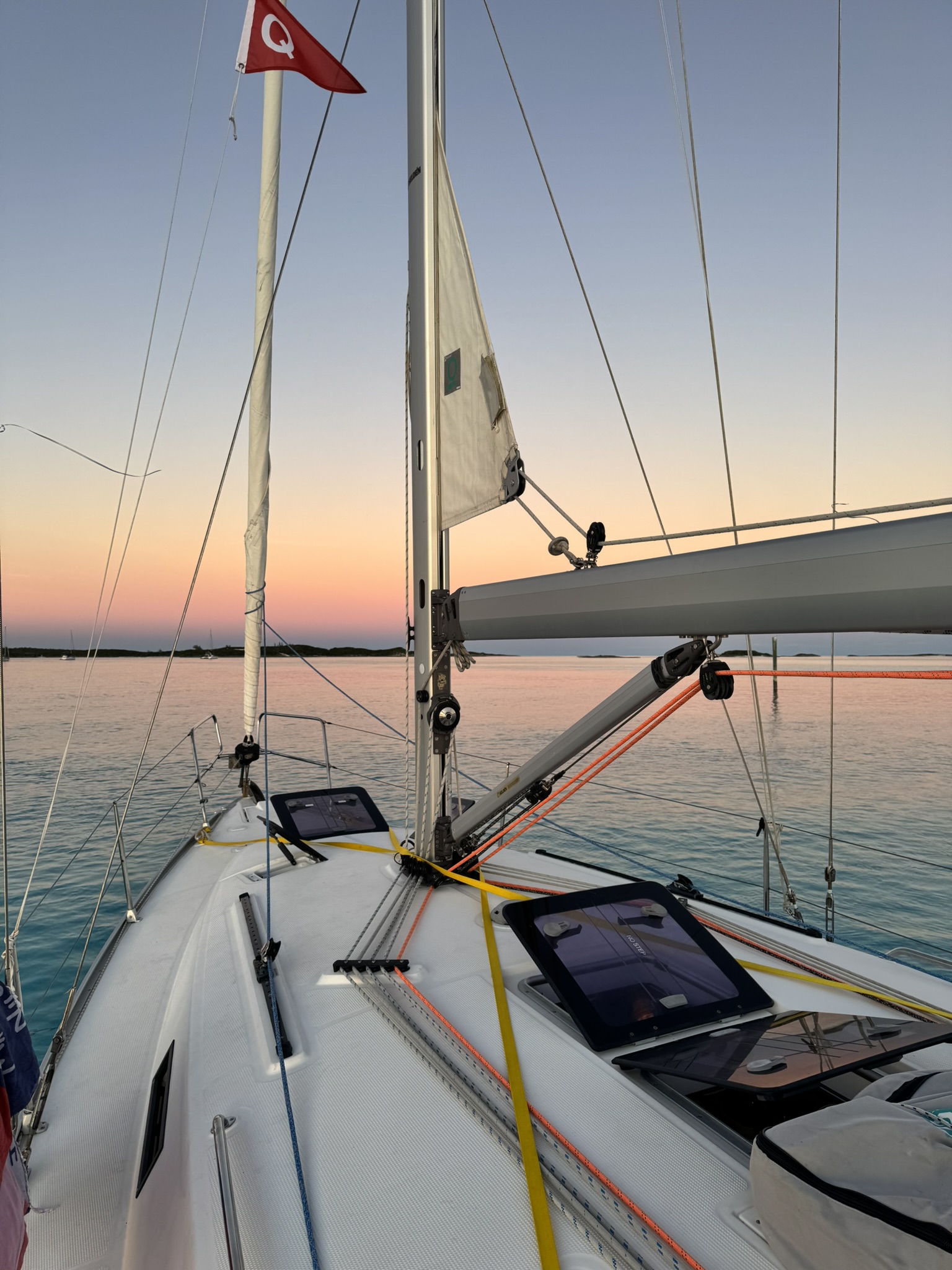 The foredeck at sunset, at anchor in flat water