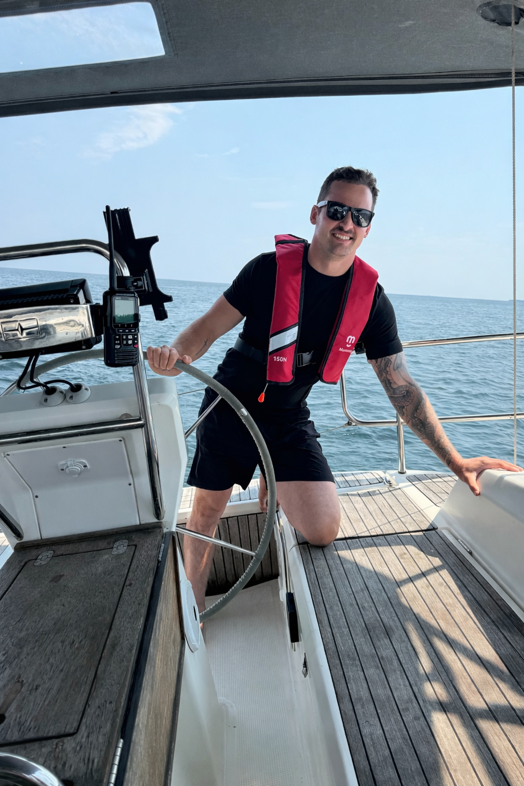 Student at the helm learning keelboat sailing