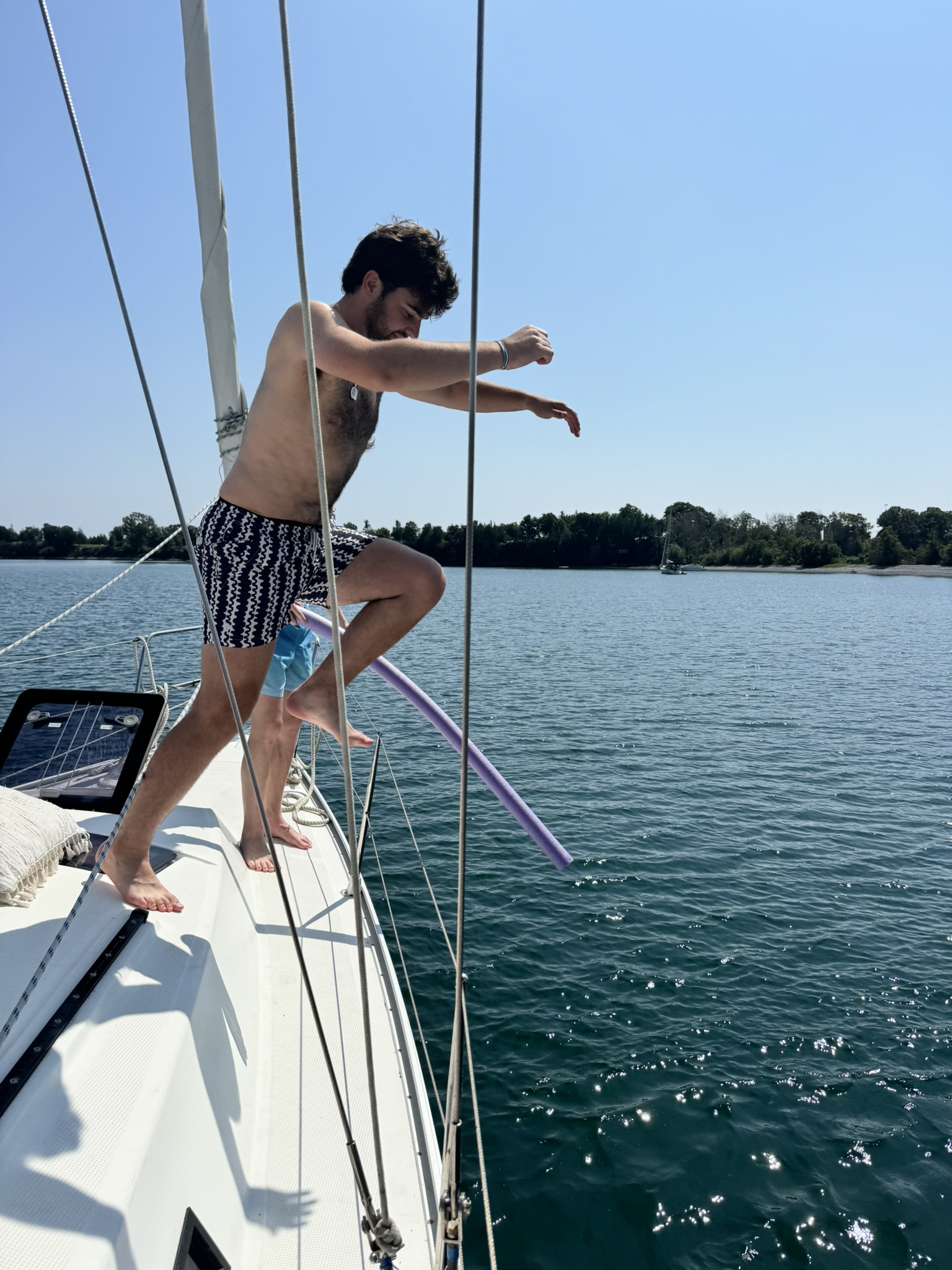 Guest jumping off the bow for a swim at a calm anchorage